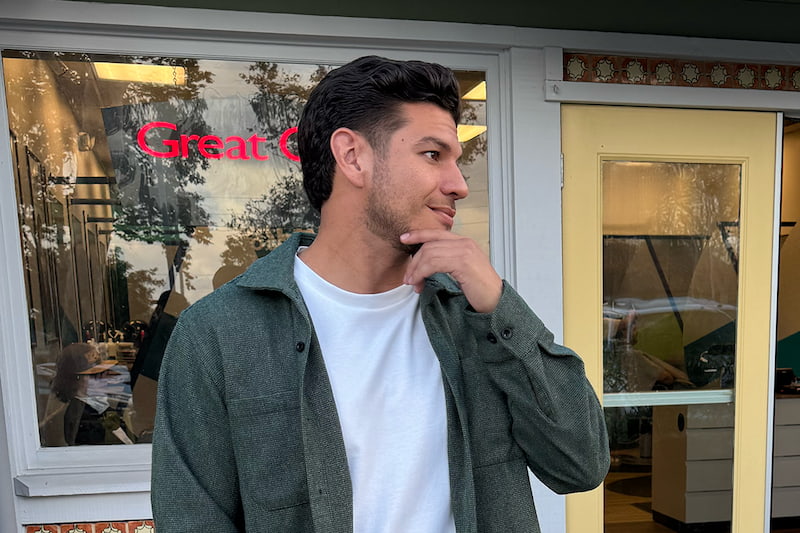 A man with a fade standing outside of a Great Clips salon.